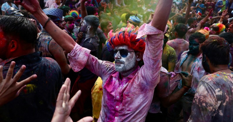 People take part in the celebrations to mark Holi, the Hindu spring festival of colours at Assi Ghat in Varanasi on March 25, 2024. (Photo by Niharika KULKARNI / AFP)