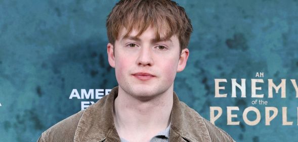 Kit Connor in a grey top and jacket