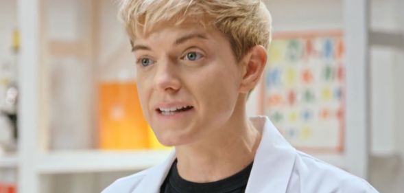 Mae Martin, in a lab coat, on set of Fluid: Life Beyond the Binary