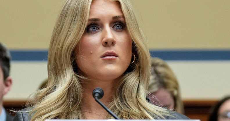 Riley Gaines sitting in a legislative table.