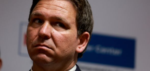 A headshot of Ron DeSantis looking upset during an event.