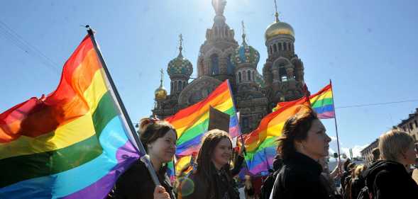 TOPSHOT - Gay rights activists march in Russia's second city of St. Petersburg May 1, 2013, during their rally against a controversial law in the city that activists see as violating the rights of gays. AFP PHOTO / OLGA MALTSEVA (Photo by OLGA MALTSEVA / AFP) (Photo by OLGA MALTSEVA/AFP via Getty Images)