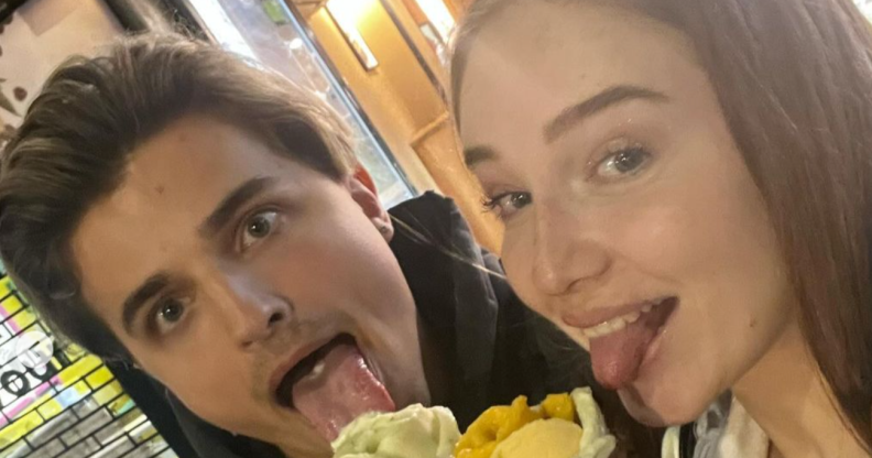Nikita Kuzmin with current girlfriend Lauren Jaine, they're both posing while eating ice cream