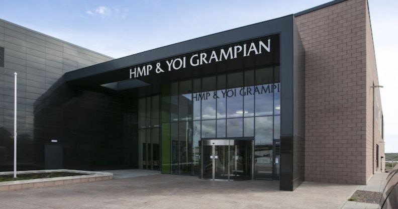 The front of the HMP Grampian, with glass pane windows and a brick building.