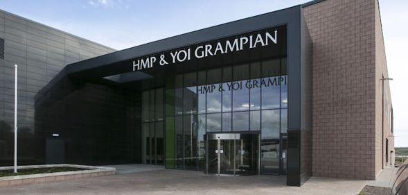 The front of the HMP Grampian, with glass pane windows and a brick building.