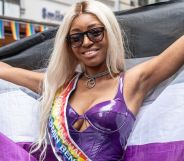 Yasmin Benoit, pictured holding up an asexual Pride flag.