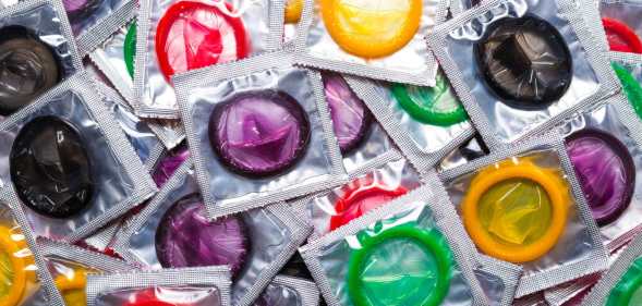 a variety of different coloured condoms