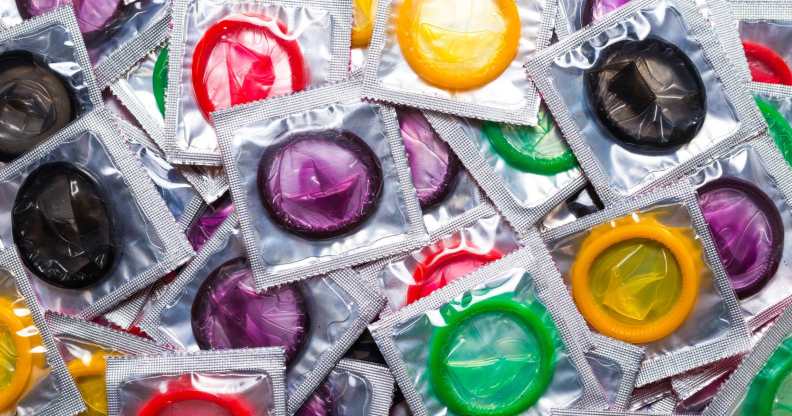 a variety of different coloured condoms