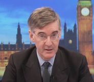 Tory MP Jacob Rees-Mogg sits at the desk as he presents on GB News