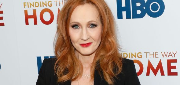 Harry Potter author JK Rowling looks towards the camera while wearing a black blazer at a press event