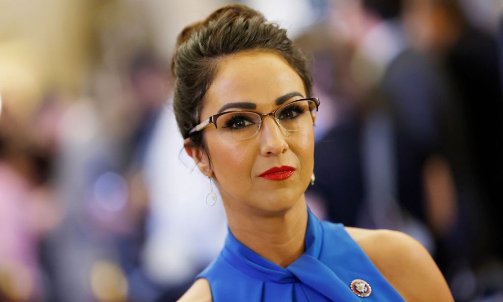 Colorado state representative Lauren Boebert (Republican) wears a blue dress as she stares towards the camera