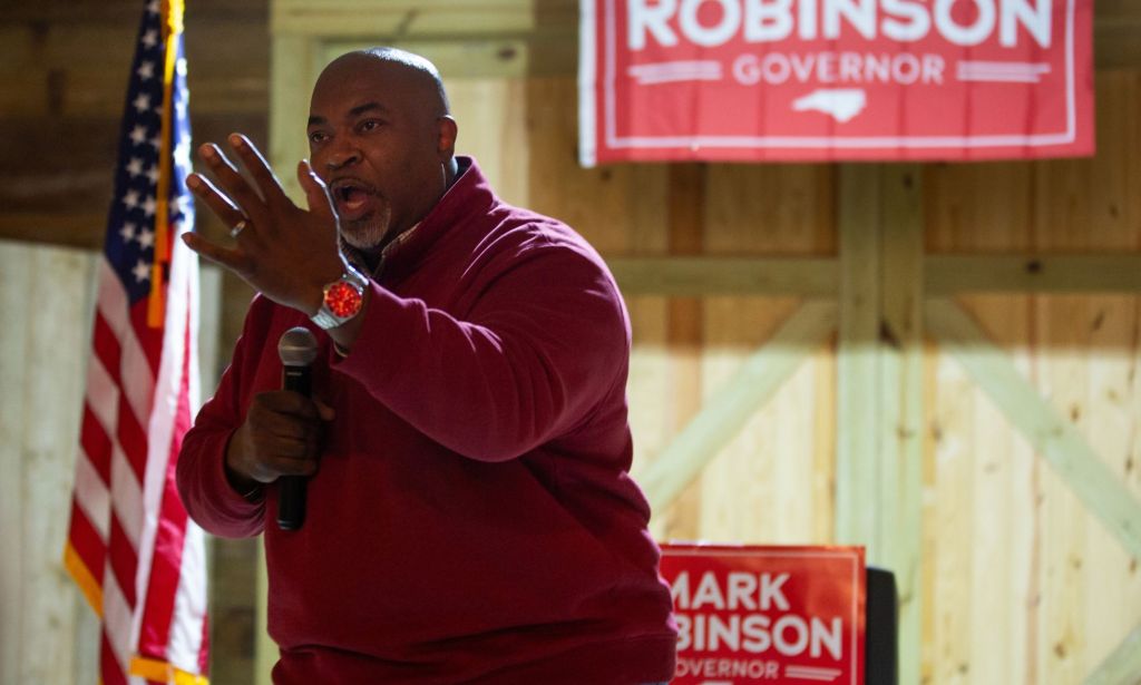 Mark Robinson wears a red shirt as he talks into a microphone during his campaign to be governor of North Carolina