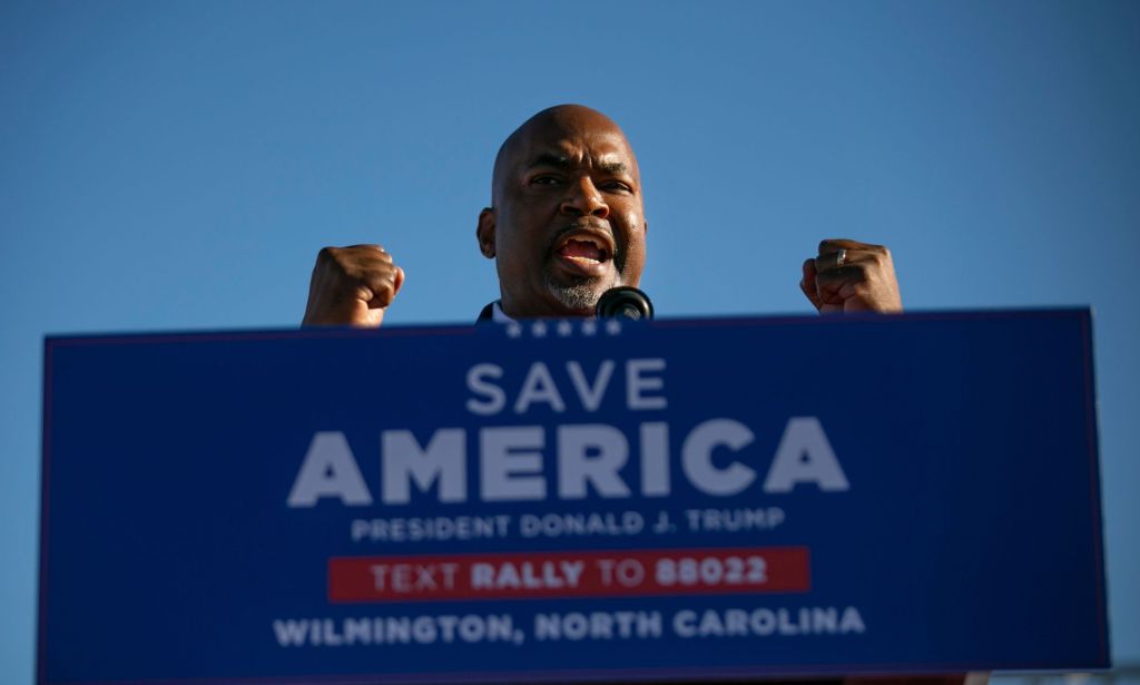 North Carolina lieutenant governor Mark Robinson speaks at a podium and gestures with both hands in the air during an event