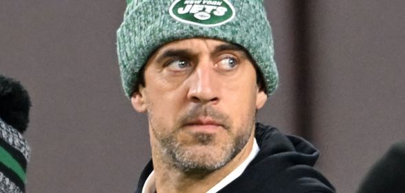 Aaron Rodgers, in a green hat, during an NFL game.