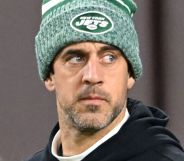 Aaron Rodgers, in a green hat, during an NFL game.