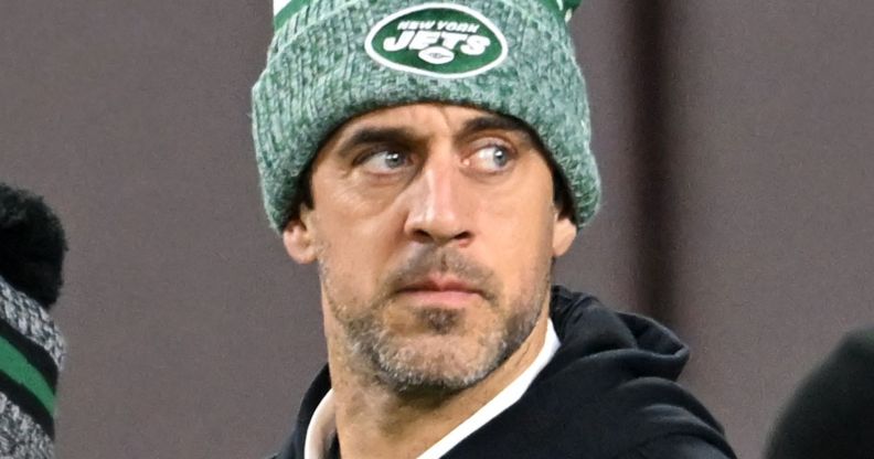 Aaron Rodgers, in a green hat, during an NFL game.