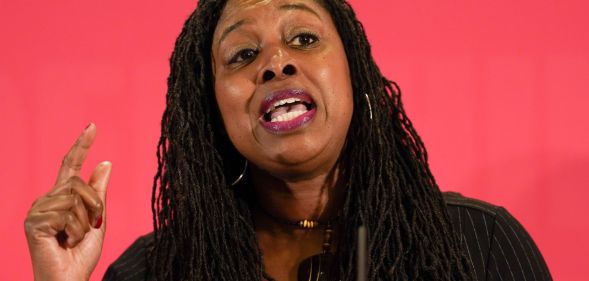 Dawn Butler with a raised finger gives a speech at a conference.