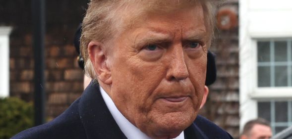 Donald Trump, standing in the rain and licking his lips.