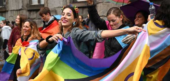 LGBT Activist holds a rainbow flag during a pride march in Belgrade, on September 17, 2022
