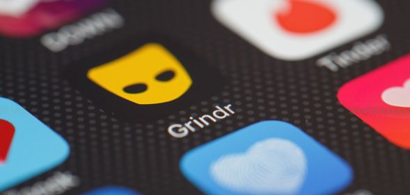 Image of the Grindr app logo on a phone