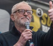 Jeremy Corbyn giving a thumbs up during a speech.