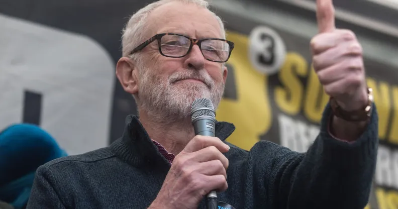 Jeremy Corbyn giving a thumbs up during a speech.