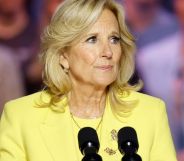 Jill Biden, wearing a yellow suit, speaks into a microphone.