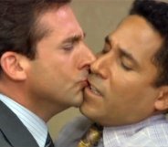 Michael Scott awkwardly kisses Oscar the accountant in a scene from The Office