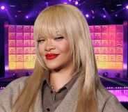 Rihanna with blonde hair and red lipstick smirking while at a FENTY X PUMA event in London, against an edited on Drag Race mainstage background.