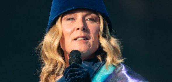 Róisín Murphy singing into a microphone while on stage at a concert.