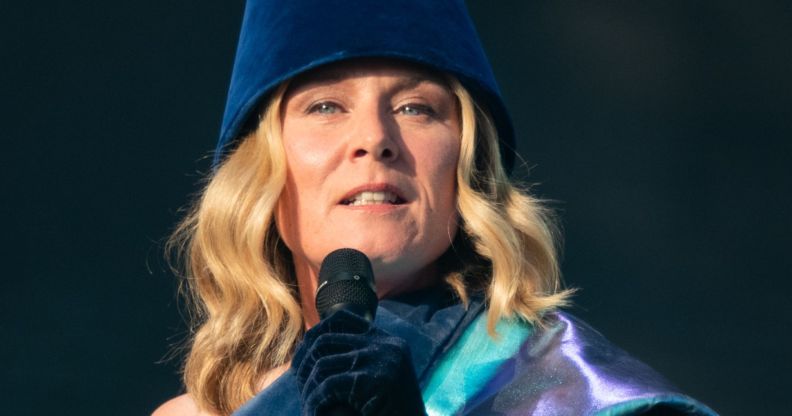 Róisín Murphy singing into a microphone while on stage at a concert.