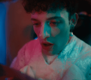 Image shows non-binary pop star in their music video for "The Code"