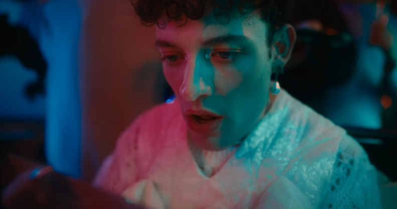 Image shows non-binary pop star in their music video for "The Code"