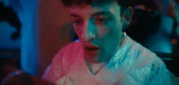Image shows non-binary pop star in their music video for "The Code"