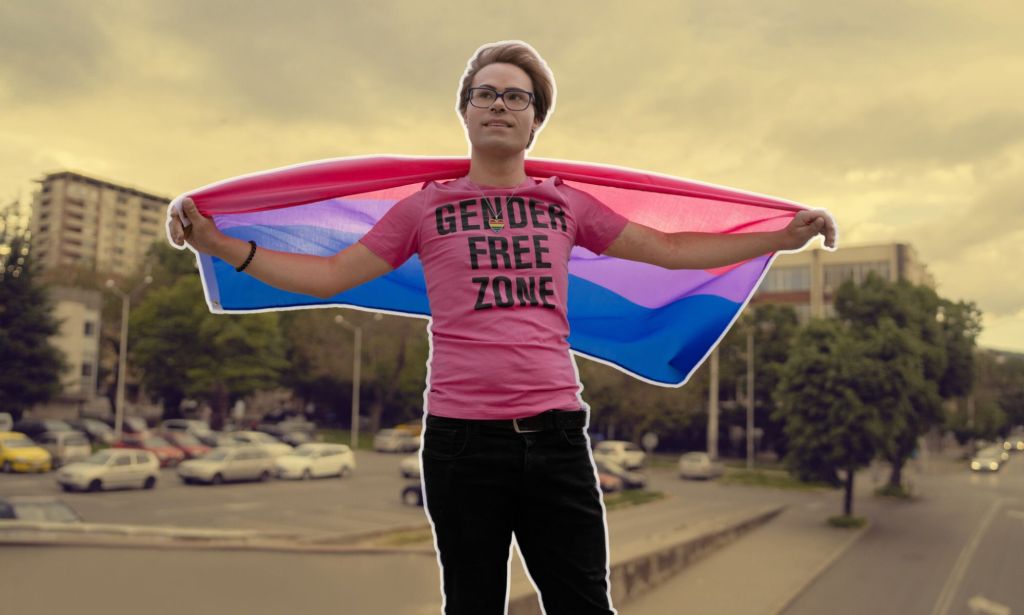 This is a decorative imaage of a non binary person posing with the bisexual flag. They are above a background that has been stylised.