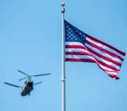 EAST HARTFORD, CT - MAY 30: An American flag waves in the wind as the Connecticut Army National Guard Aviation Unit fly one CH-47 Chinook and two UH-60 Blackhawks for a flyover during the performing of the national anthem prior to the NCAA Division I Men's Lacrosse Championship game between the Cornell Big Red and Maryland Terrapins on May 30, 2022, at Rentschler Field at Pratt & Whitney Stadium in East Hartford, Connecticut. (Photo by Erica Denhoff/Icon Sportswire via Getty Images)