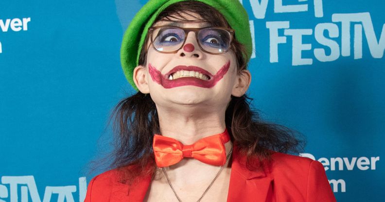 The People's Joker star Vera Drew on the red carpet wearing a joker costume.