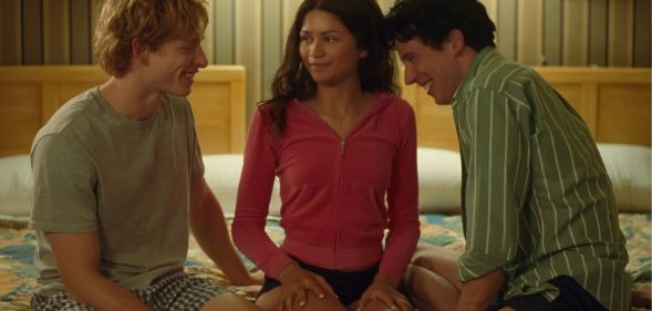 A still from Challengers featuring Mike Faist, Zendaya and Josh O'Connor on a bed.