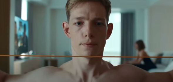 Mike Faist shirtless in a still from Challengers. He looks solemn.