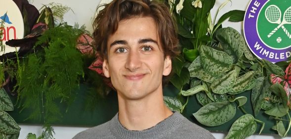 Sebastian Croft smiling in a grey top at Wimbledon.