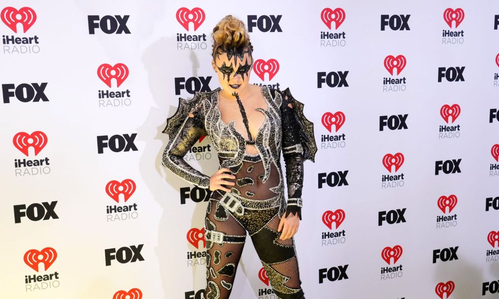 JoJo Siwa in a black mesh bodysuit and KISS inspired makeup.