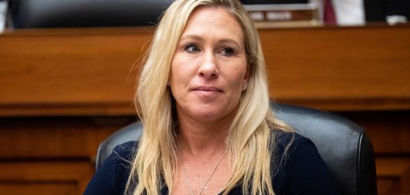 Georgia Republican congresswoman Marjorie Taylor Greene wears a black top as she sits at a desk