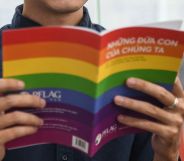 In this picture taken on May 17, 2021, candidate for Vietnam's National Assembly Luong The Huy poses with a book about LGBT issues in his office in Hanoi. - As an LGBTI activist, legal whizz kid and Vietnam's first openly gay candidate running for a seat in its rubber-stamp parliament, Luong The Huy is determined to lead long-lasting change for the country's marginalised communities. - TO GO WITH Vietnam-homosexuality-parliament-politics, INTERVIEW by Tran Thi Minh Ha (Photo by Nhac NGUYEN / AFP) / TO GO WITH Vietnam-homosexuality-parliament-politics, INTERVIEW by Tran Thi Minh Ha (Photo by NHAC NGUYEN/AFP via Getty Images)