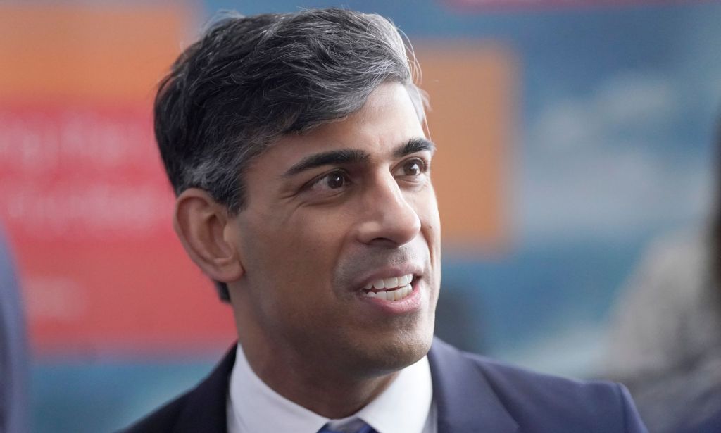UK prime minister Rishi Sunak wears a suit and tie as he looks off camera