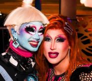 A photo of Drag Race season 16 contestants Dawn and Amanda Tori Meating in drag smiling.
