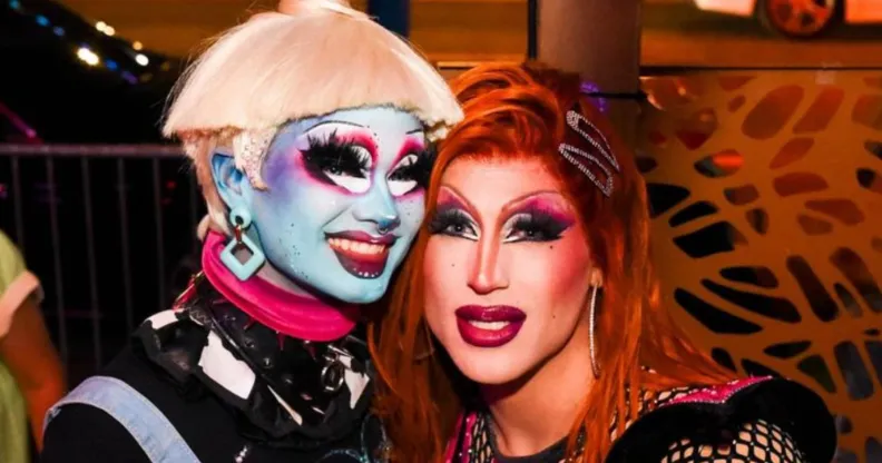A photo of Drag Race season 16 contestants Dawn and Amanda Tori Meating in drag smiling.