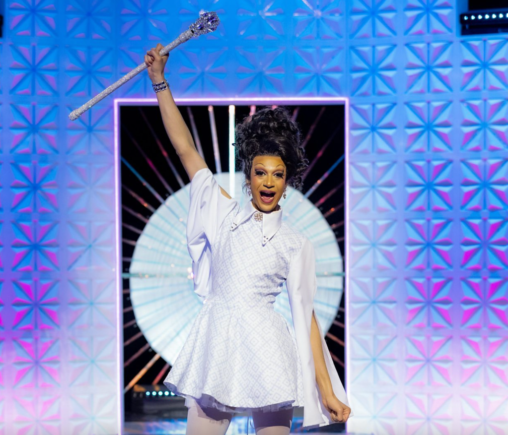 Drag Race UK vs The World season two winner Tia Kofi holding her sceptre in the air.