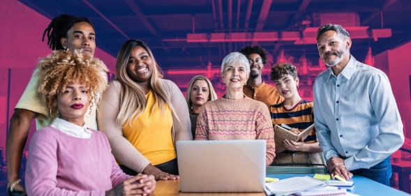 This is a diverse group of colleagues gathered around a table.