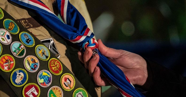 A person holds the tie of a Boy Scout.