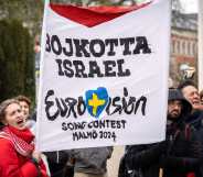 Participants hold up flags and placards during a demonstration outside the City Hall in Malmö, Sweden on April 10, 2024 in connection with the municipal board's consideration of a citizens' proposal to stop Israel's participation in the Eurovision Song Contest. The demo was organised by the citizens' initiative 'No Eurovision in Malmö with Israel's participation'. (Photo by Johan NILSSON / TT News Agency / AFP) / Sweden OUT (Photo by JOHAN NILSSON/TT News Agency/AFP via Getty Images)
